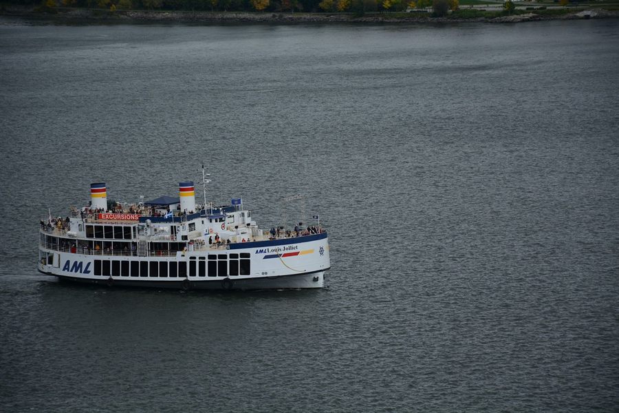A white passenger boat on the dark water of the St. Lawrence near Quebec City